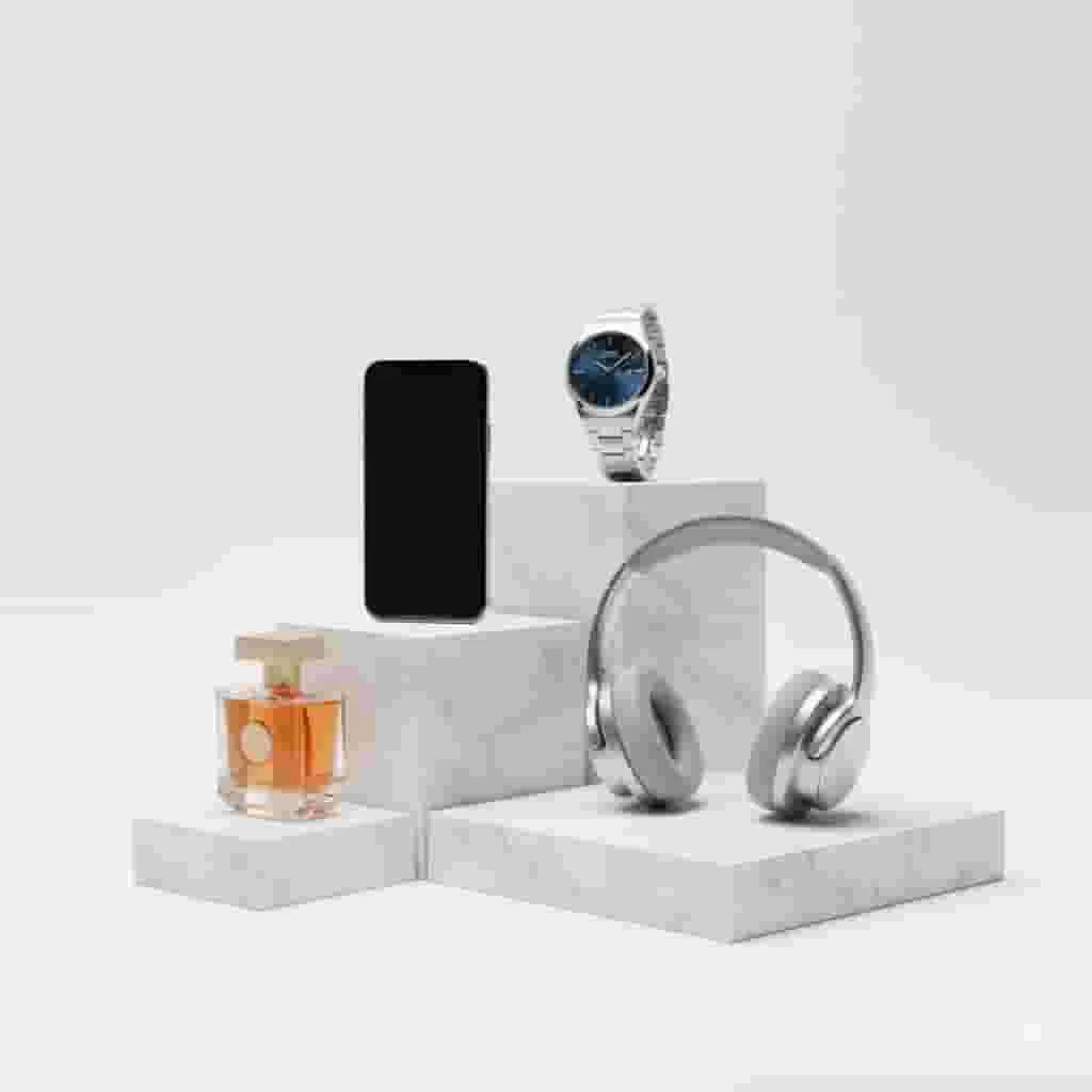 Professional 3D product rendering displaying luxury consumer goods including watch, headphones, and electronics with studio lighting